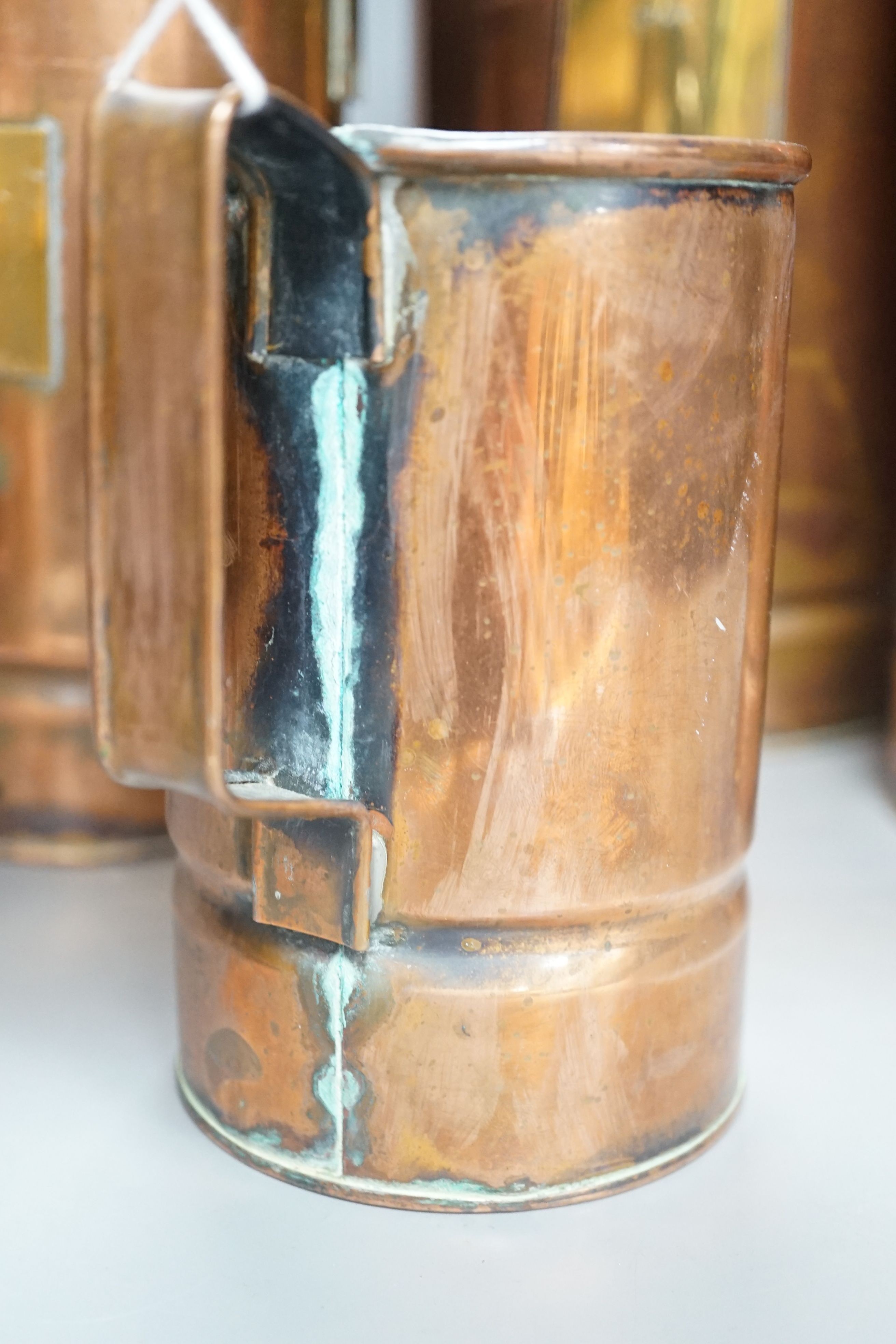 A graduated set of four copper and brass grain measures, tallest 39.5 cms high.